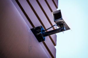 gray surveillance camera on gray wall