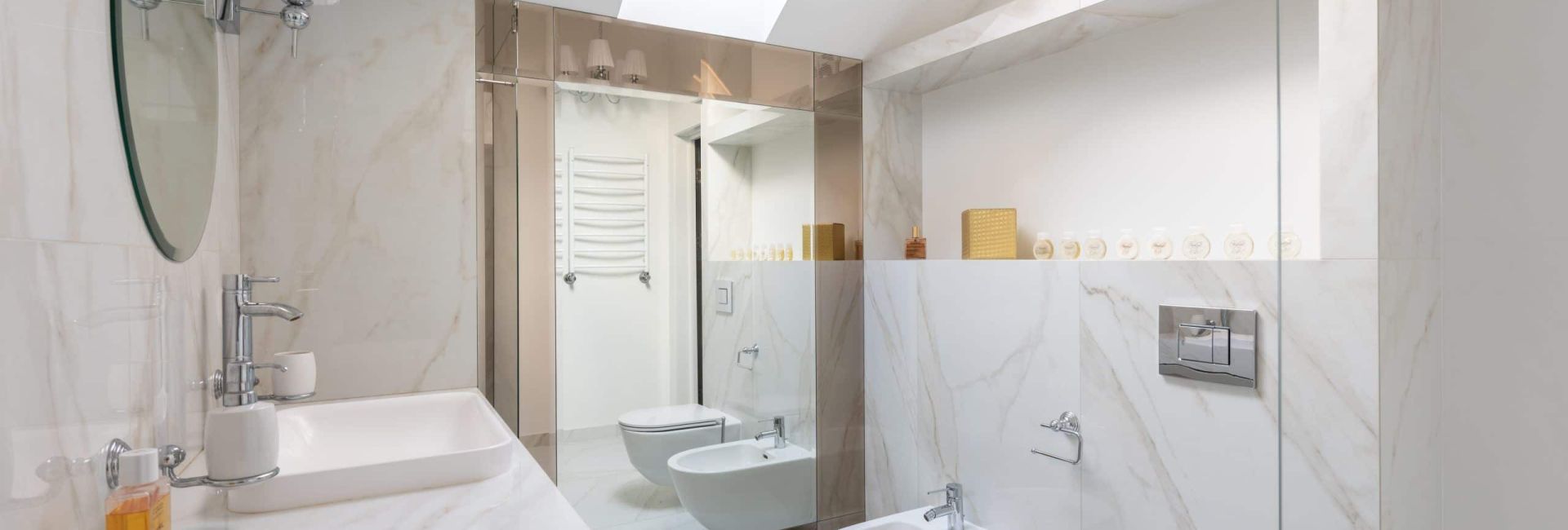 Luxurious marble bathroom with modern fixtures, skylight, and minimalist design in a compact space