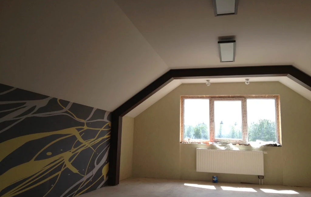 Spacious loft room with abstract mural and large window, featuring natural light and modern ceiling lights