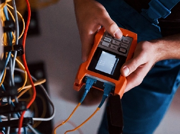Person using network cable tester for electrical system diagnostics