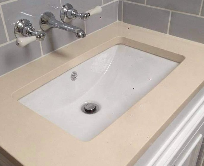 Modern bathroom sink with chrome wall-mounted taps and grey tiled backsplash