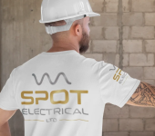 Man in hard hat and SPOT Electrical shirt on construction site