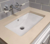 Modern bathroom sink with chrome wall-mounted taps and grey tiled backsplash