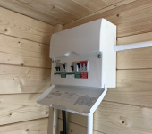 Electrical circuit breaker box on wooden wall in a cabin, showcasing safety switches and detailed instructions