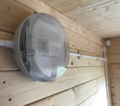 Round wall light fixture on wooden panelled wall in a cosy interior setting