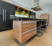 Modern kitchen with sleek wooden island, black cabinets, and stylish seating for a contemporary look